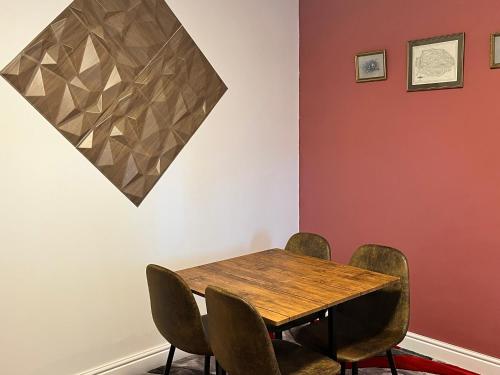 a dining room with a wooden table and chairs at Bacton Coastal Retreat in Bacton