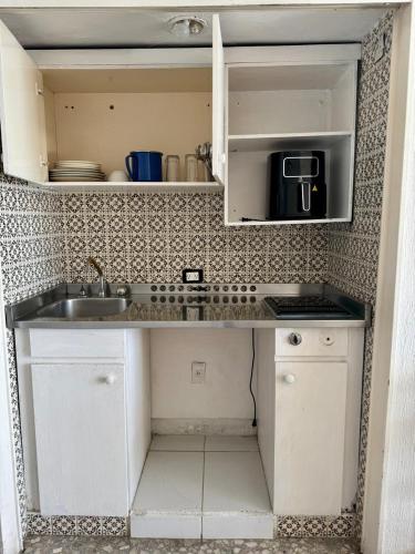 a kitchen with a sink and a counter top at Suites Omega Torres Gemelas in Acapulco