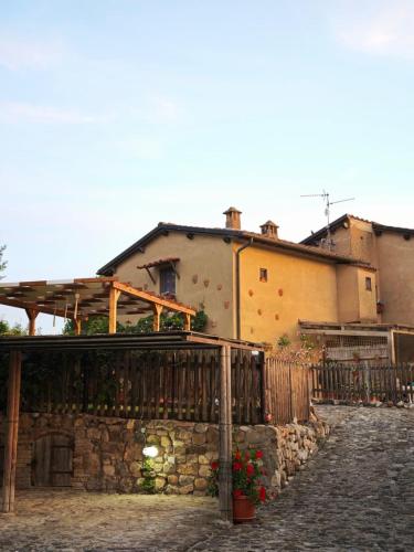 a building with a fence in front of a street at PAPAVERO ROSSO in San Gimignano