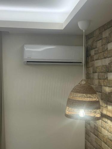 a pendant light hanging from the ceiling in a room at Dolphin Hotel Apartments in Karpathos Town