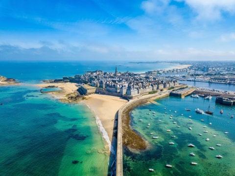 an aerial view of a beach with boats in the water at Private Spa and Garden 10 min from Mont St-Michel in Pontorson