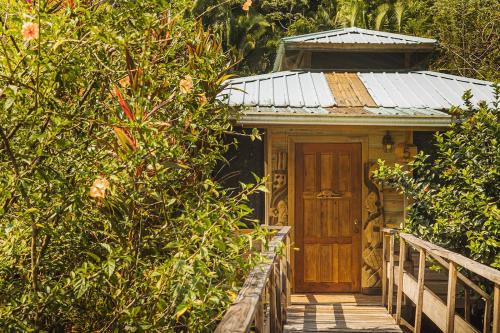 a small house with a wooden door on a porch at Jaguar Creek in Good Living Camp