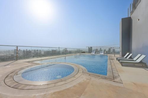 a swimming pool on the roof of a building at Free housekeeping visits during your stay - StayShort - Sports City Studio sleeps 2 with Swimming Pool in Dubai