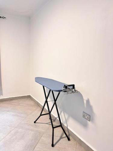 a blue table in a white room with a wall at Apartment unit-Luxury in Kampala