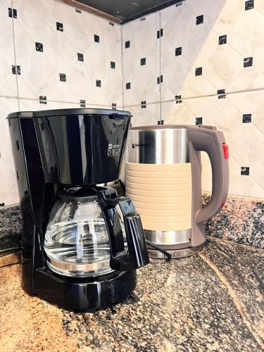 a coffee maker sitting on top of a kitchen counter at Apartment unit-Luxury in Kampala