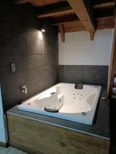 a bath tub with a sink in a room at Cabañas el tigre in Mazamitla