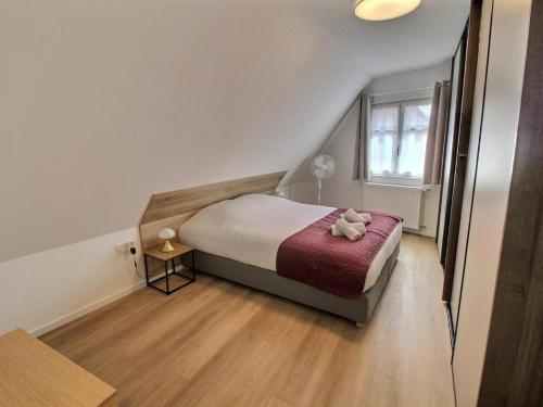 una camera da letto con un letto con un orsacchiotto sopra di Gîtes rénovés avec goût au coeur du vignoble, route des vins, Alsace, Gueberschwihr a Gueberschwihr