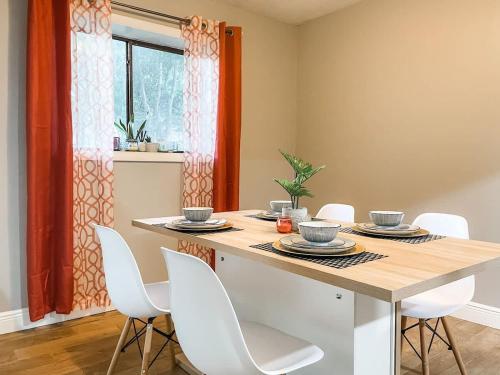 a dining room with a table and white chairs at Lovely 3 Bd 2 bath townhome in Perkins