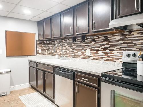 a kitchen with stainless steel appliances and brown cabinets at Lovely 3 Bd 2 bath townhome in Perkins