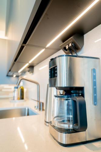 a coffee maker sitting on top of a kitchen counter at Karlatornet Sky Level in Gothenburg