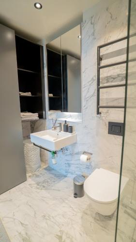 a bathroom with a sink and a toilet at Karlatornet Sky Level in Gothenburg