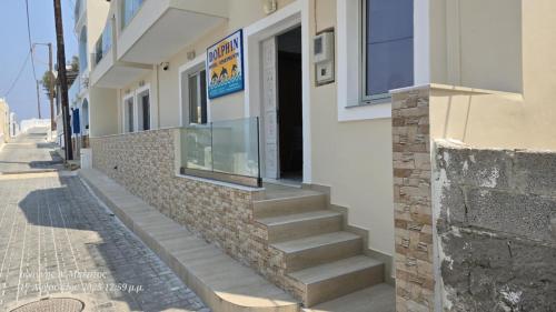 a building with stairs on the side of a street at Dolphin Hotel Apartments in Karpathos Town