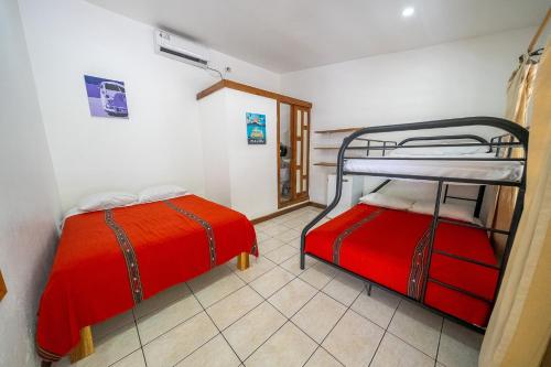 a bedroom with two bunk beds in a room at Santa Toro Inn in Santa Teresa Beach
