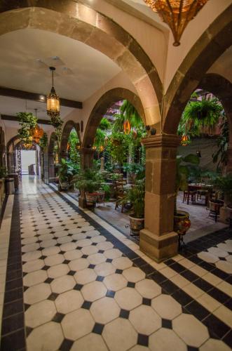 a lobby with a checkered floor in a building at Hotel Mansión Virreyes in San Miguel de Allende