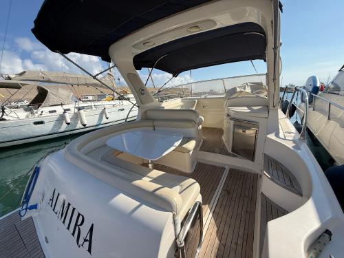 a boat sitting in the water next to other boats at Giannina House 22 in Cefalù