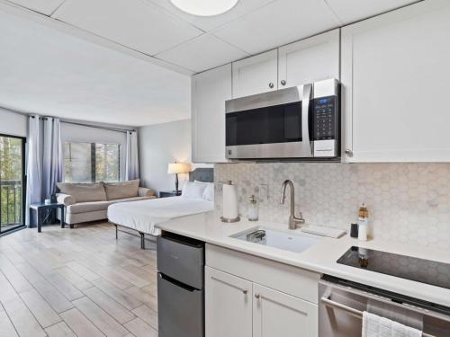 a kitchen with a sink and a living room at JS Luxury Vacation in Orlando