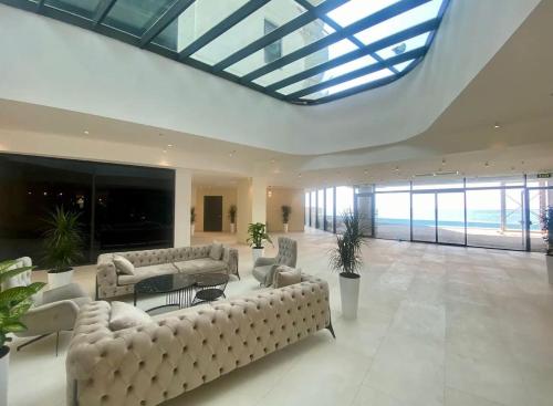 a large living room with couches and a glass ceiling at Bamboo Beach Tsikhisdziri Seaview Flat 839 in Tsikhisdziri