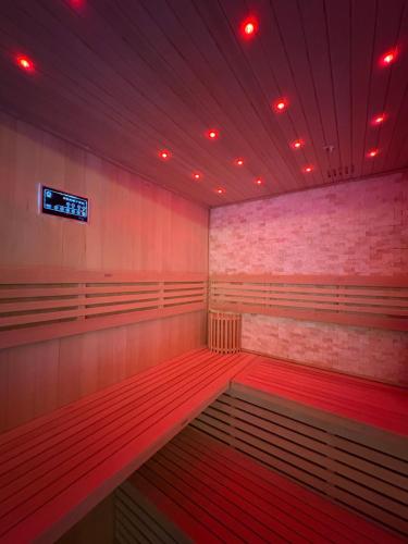a boiler room with red lights and a scoreboard at Hotel SPA GBC Arcade in Arcade