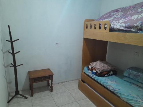 a bedroom with a bunk bed and a table at Pousada da Prainha in Mairiporã