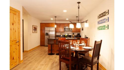 a kitchen and dining room with a table and chairs at Lift 1 Lookout - NEW PROPERTY - WiFi - Ski Locker - Mountain Views - Shops - Restaurants in Twining