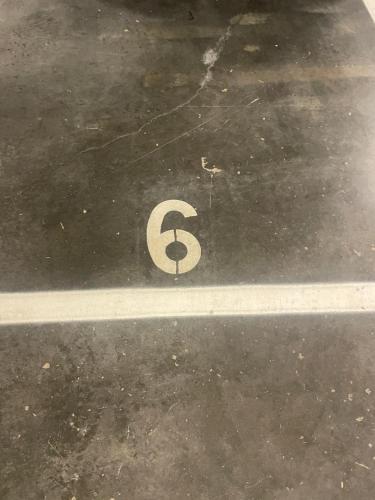a number six on the floor of a parking lot at Karlatornet Sky Level in Gothenburg