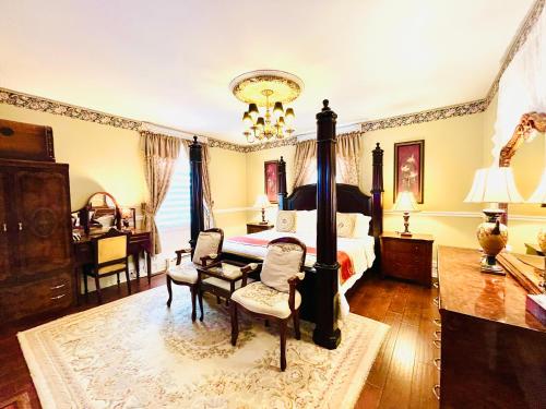 a bedroom with a bed and a table and chairs at Barker House 3# Suite-heart of oldtown in Niagara on the Lake