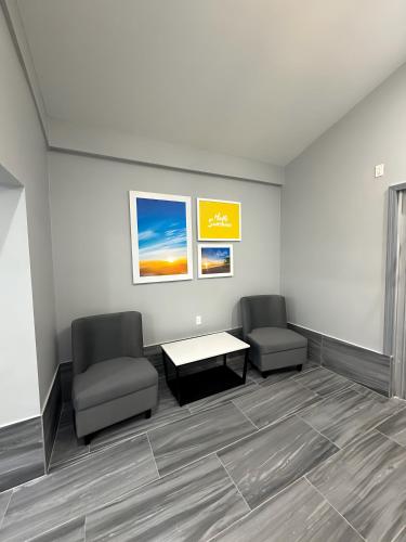 a waiting room with two chairs and a table at Days Inn & Suites by Wyndham Texas City in Texas City