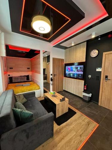 a living room with a couch and a tv at TGHA Luxury Apartments in Athlone in Athlone