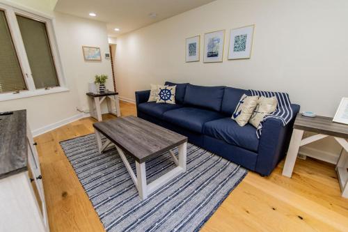 a living room with a blue couch and a table at Naval Academy Gate 1 in Annapolis