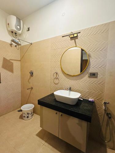 a bathroom with a sink and a mirror at Aarudhra villa in Chennai