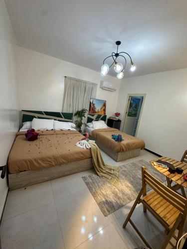 a bedroom with two beds and a chandelier at king pyramids in Cairo