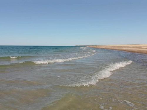 a beach with waves coming in from the ocean at 7 person holiday home in Fjerritslev-By Traum in Fjerritslev