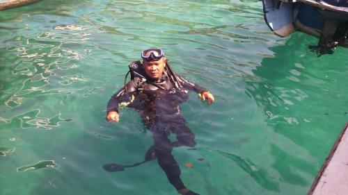 a man in the water with a diver at Eco Moringa Garden in Banyuwedang
