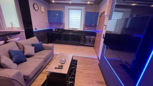 a large living room with a couch and a kitchen at TGHA Luxury Apartments in Athlone in Athlone