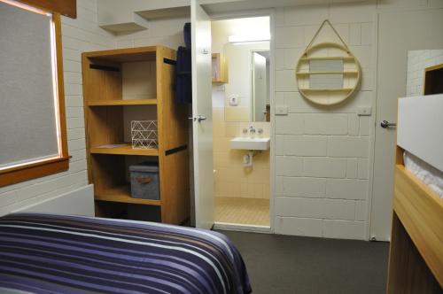 a small bathroom with a sink and a mirror at Ripparoo Lodge in Falls Creek