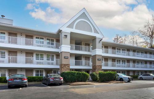 a large building with cars parked in a parking lot at Extended Stay America Select Suites - Nashville - Airport in Nashville
