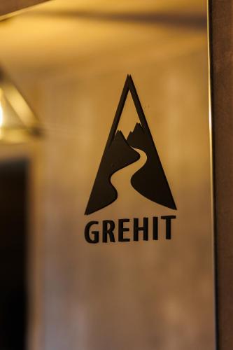 a sign on a door with thegritt logo at Grehit House in Kozmacz