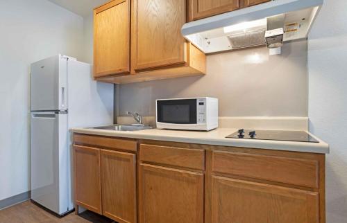 a kitchen with a sink and a white refrigerator at Extended Stay America Select Suites - Fort Myers in Fort Myers