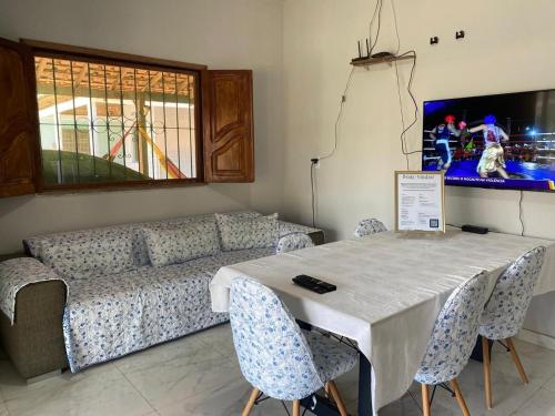 a living room with a couch and a table and chairs at Casa de Praia em Joanes - Salvaterra in Joanes