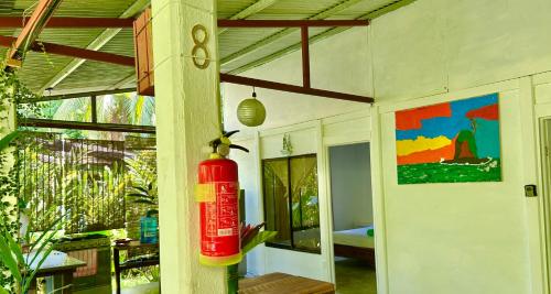 a red fire extinguisher on a wall in a room at Villas Itaita Beach Cabins in Punta Uva
