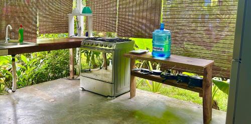 a kitchen with a stove and a bottle of water at Villas Itaita Beach Cabins in Punta Uva
