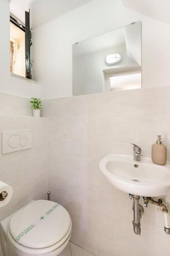 a bathroom with a toilet and a sink at Ganga House - Mini Loft Moderno-Free Parking in Lastra a Signa