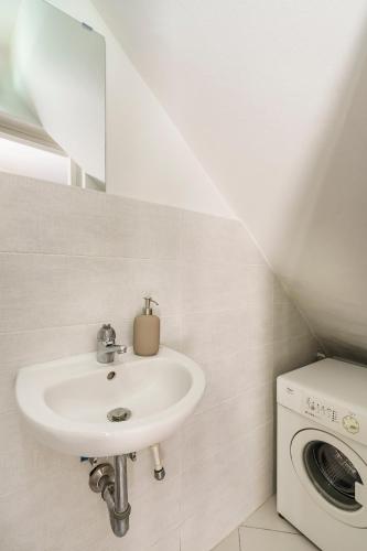 a bathroom with a sink and a washing machine at Ganga House - Mini Loft Moderno-Free Parking in Lastra a Signa
