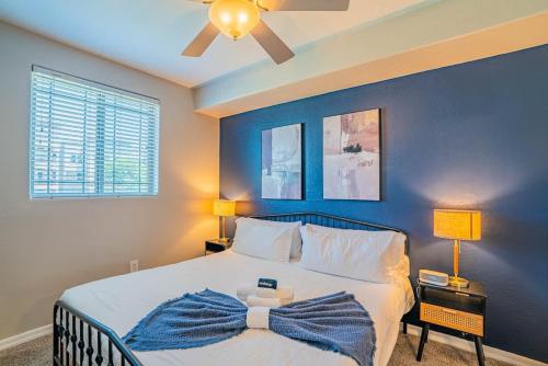 a bedroom with a bed with a blue wall at Spacious Near ASU Sloan Pk Gym Parking Pool WD in Tempe
