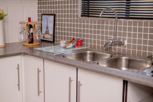 a kitchen counter with a stainless steel sink at SinoVilla397 in Pretoria