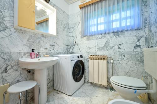 a bathroom with a washing machine and a sink at Family friendly house with a swimming pool Benkovec, Zagorje - 24902 in Bednja