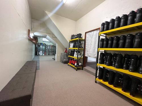 a room filled with shelves filled with lots of shoes at Snowfox Nozawa in Nozawa Onsen