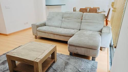 a living room with a couch and a coffee table at Levy-Cardoso Apartment in Praia
