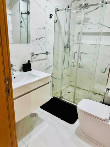 a bathroom with a shower and a toilet and a sink at Levy-Cardoso Apartment in Praia