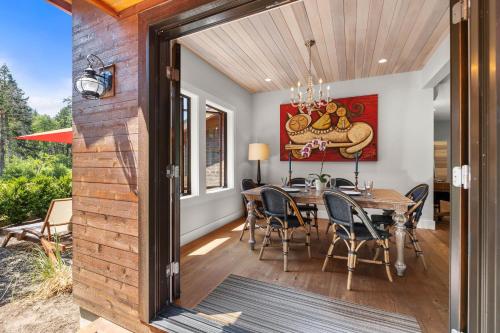 a dining room with a table and chairs at Mountain-View Retreat with Hot Tub & Waterfalls in Cascade Locks
